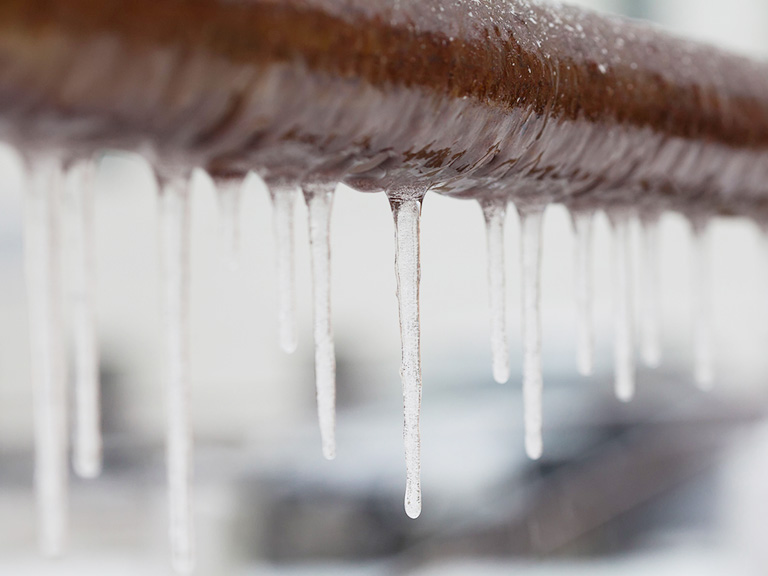 image of icicles hanging off of pipes
